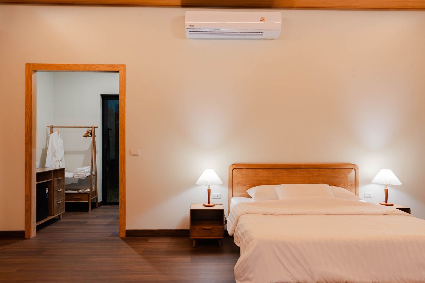 Bedroom with wooden bed and walk-in wardrobe