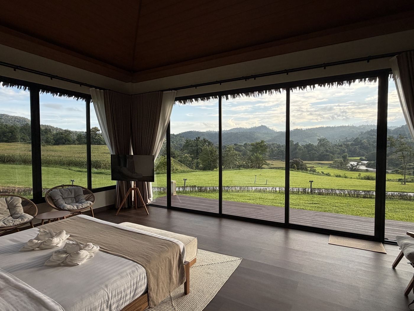 Corner glass bedroom looking over fields and river