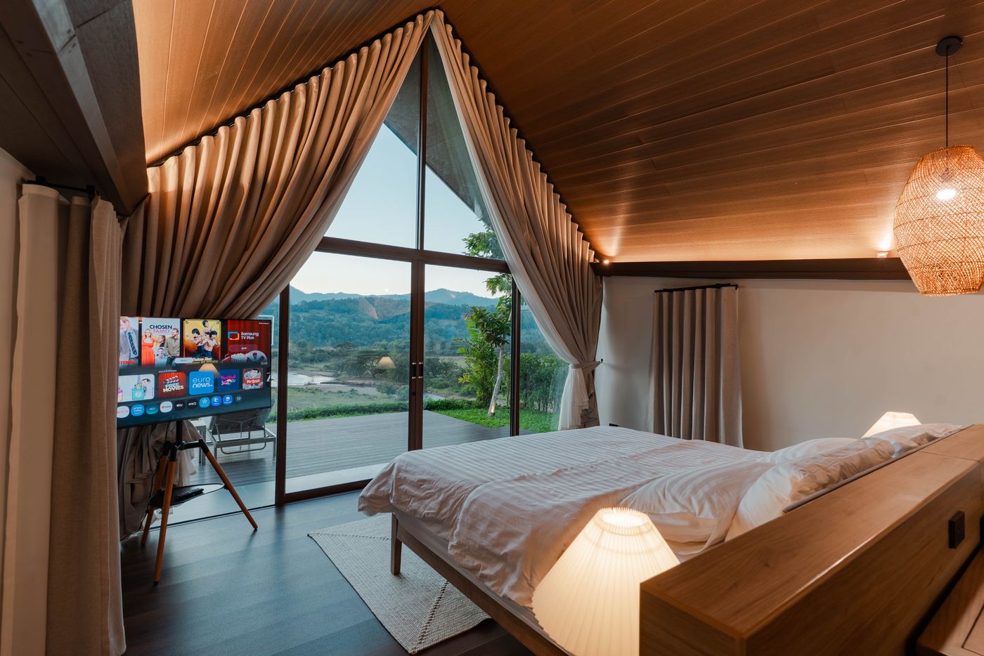 A-frame bedroom with full-height glass and river view